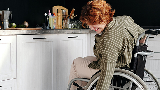 woman-sitting-on-wheelchair-while-touching-her-cat-4064423